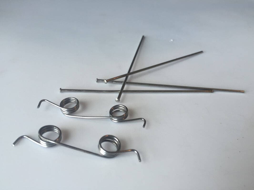 The springs (bottom left) and trigger rods (upper right).