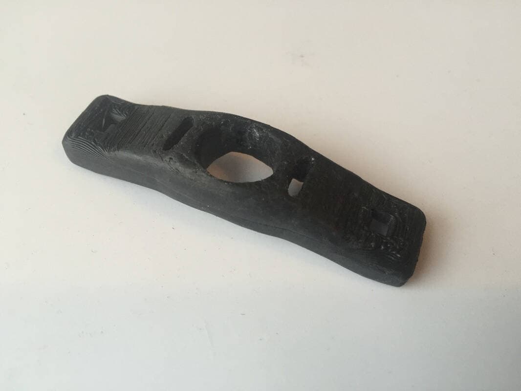 The 3D printed plastic trigger.
