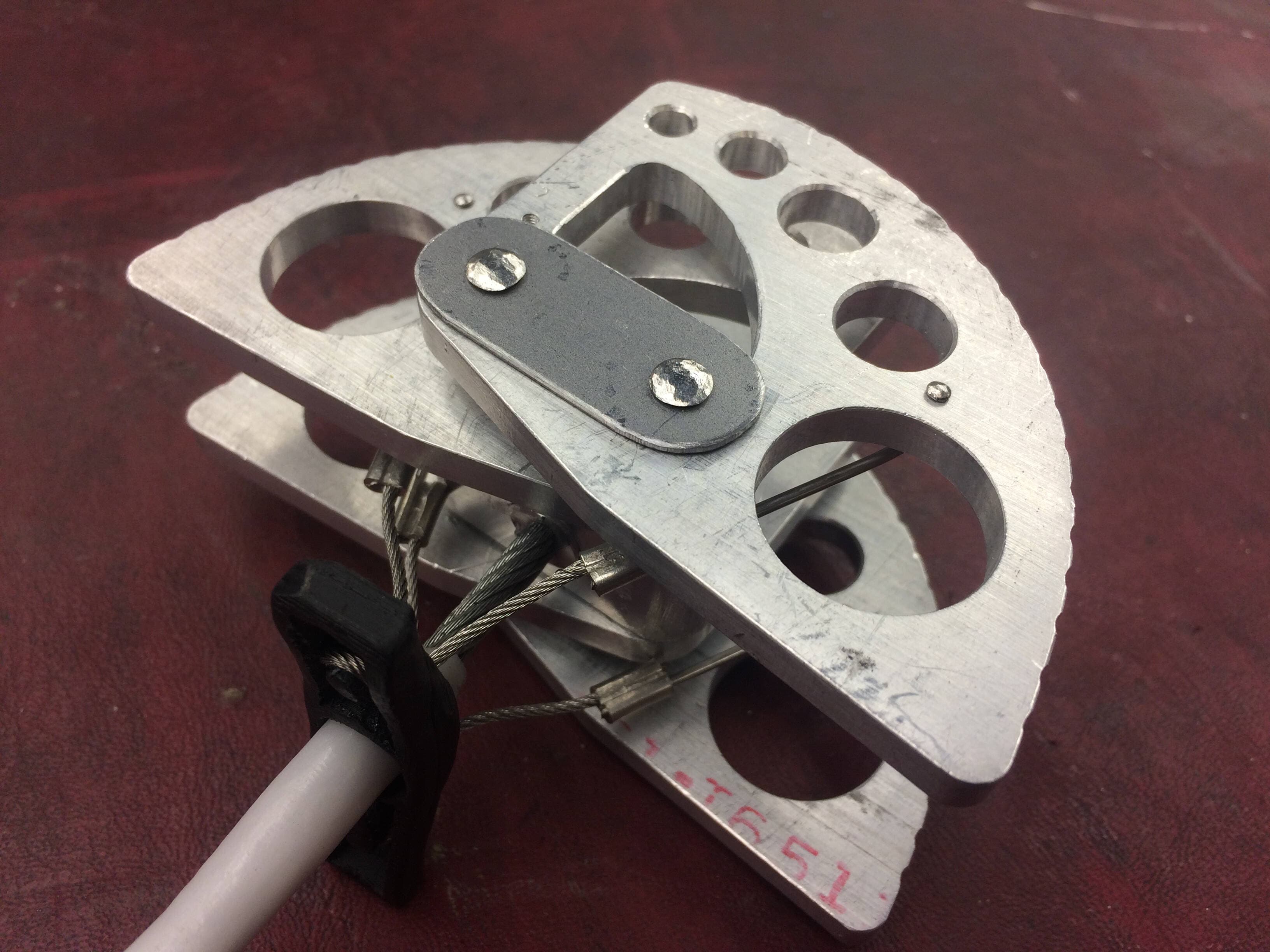 In the fully assembled cam you can see the trigger rods threaded through the lobes and crimped back to the trigger wires.