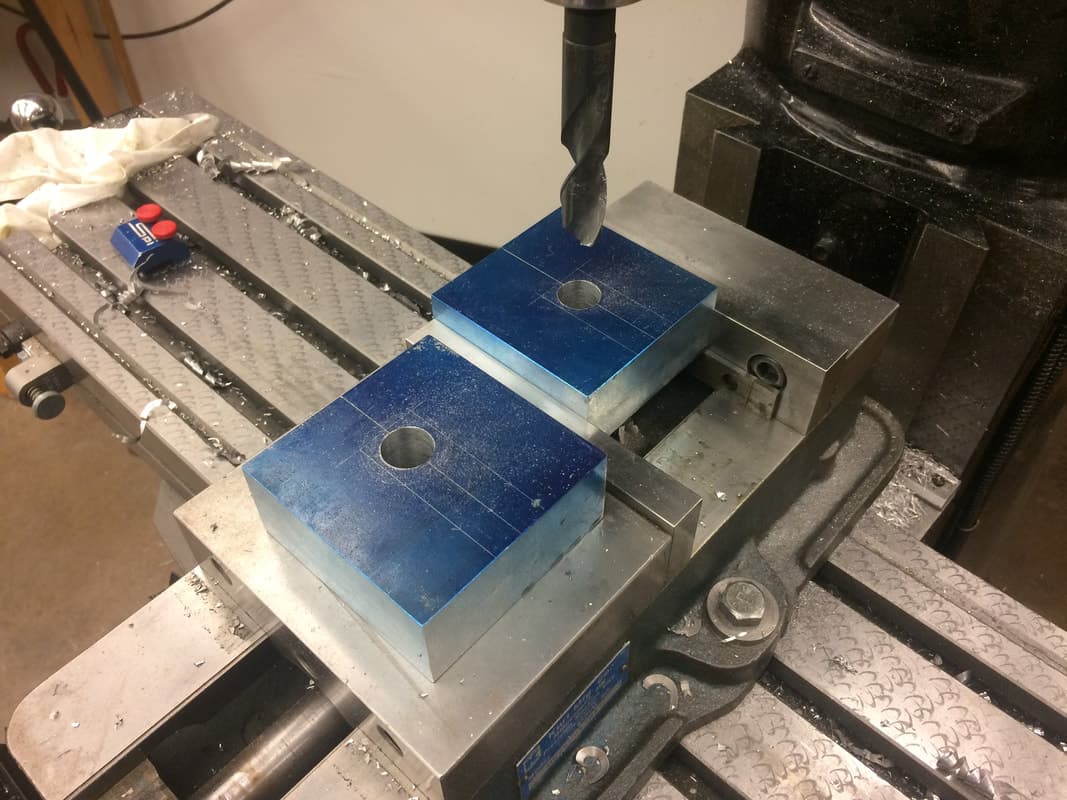Drilling out the center of the elbow, just before using the bandsaw to cut out the "slice of the pie" along the pair of marked lies from the outside to the center hole.