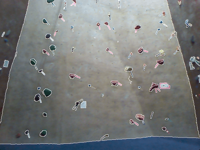 Indoor rock climbing wall with holds outlines overlayed