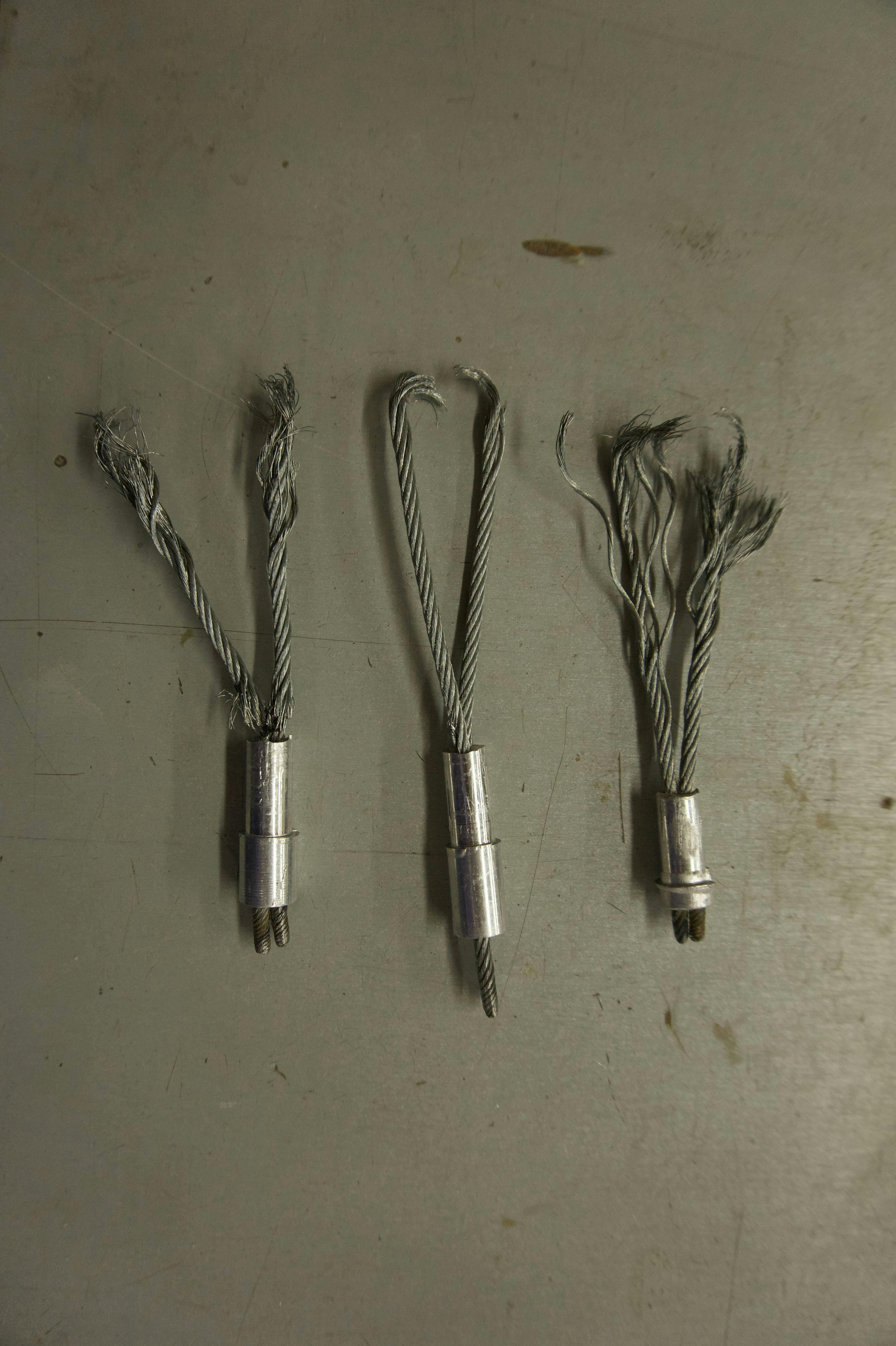 Three final designs for swaged stems, broken after drop testing.